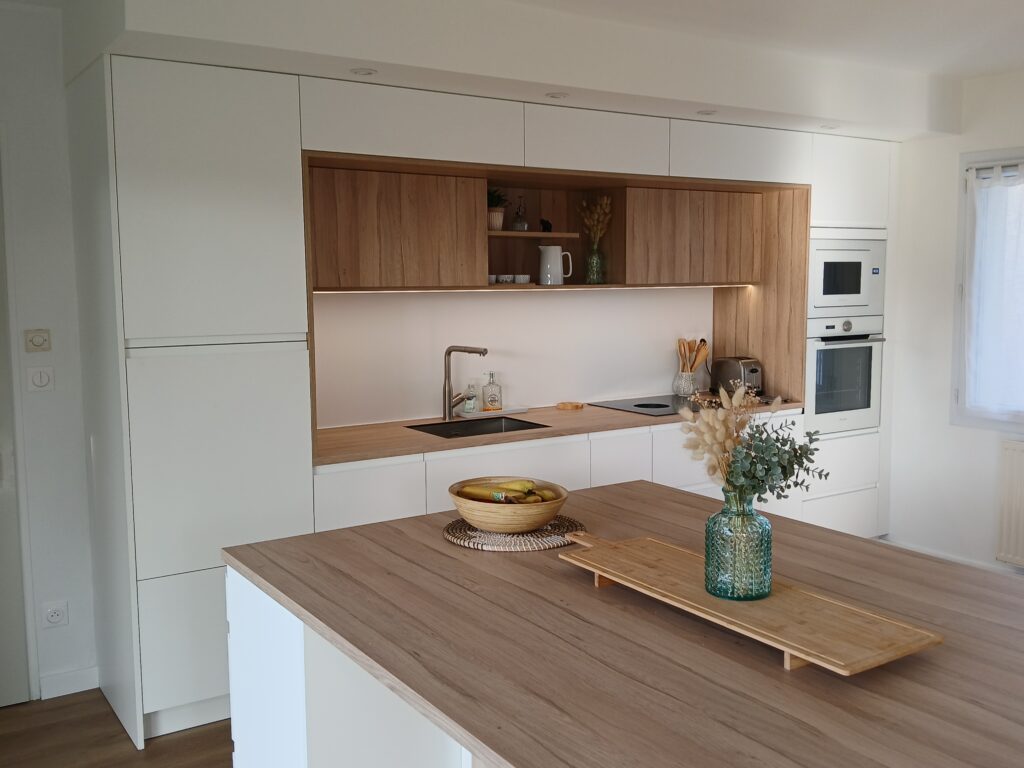 Conception de cuisine moderne blanche et bois avec îlot central en Vendée.